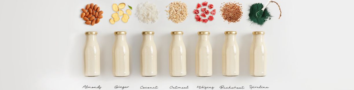 Seven plant-based milks in bottles with their ingredients